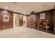 Finished basement offers a cozy home theater setup with raised platform and adjacent billiards room at 7415 Northampton Ct, Cumming, GA 30040