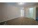 This bedroom features neutral walls, plush carpeting, and an ensuite bathroom and closet at 7415 Northampton Ct, Cumming, GA 30040