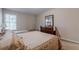 This bedroom features a neutral palette, carpeted floor, and is furnished with twin and full-sized beds at 7415 Northampton Ct, Cumming, GA 30040