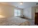 Bedroom with neutral decor, closet, and large window providing natural light at 7415 Northampton Ct, Cumming, GA 30040
