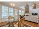 Sunlit breakfast nook with a glass table, wicker chairs, and view of the modern living room at 7415 Northampton Ct, Cumming, GA 30040
