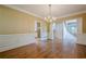 Elegant dining room with hardwood floors, chandelier, and large windows for bright dining at 7415 Northampton Ct, Cumming, GA 30040