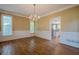 Elegant dining room with hardwood floors, chandelier, and large windows for bright dining at 7415 Northampton Ct, Cumming, GA 30040