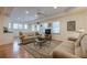 Cozy entertainment room with a comfortable couch, wood floors, recessed lighting, and multiple windows at 7415 Northampton Ct, Cumming, GA 30040