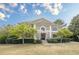 Charming two-story home with a manicured lawn, beautiful landscaping, and classic architectural details at 7415 Northampton Ct, Cumming, GA 30040