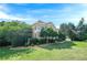 Exterior view of a well-manicured lawn, mature trees and traditional home at 7415 Northampton Ct, Cumming, GA 30040