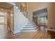 Elegant foyer with hardwood floors, staircase, and tall ceilings for a grand entrance at 7415 Northampton Ct, Cumming, GA 30040