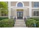 Elegant double front doors, stone steps, wrought iron railings, and manicured landscaping at 7415 Northampton Ct, Cumming, GA 30040