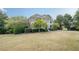Well-manicured front lawn and mature trees add to the curb appeal of this inviting home at 7415 Northampton Ct, Cumming, GA 30040
