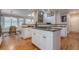 Modern kitchen with white cabinets, granite countertops, stainless steel appliances, and hardwood floors at 7415 Northampton Ct, Cumming, GA 30040