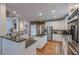 Modern kitchen with granite countertops, white cabinets, and stainless steel appliances at 7415 Northampton Ct, Cumming, GA 30040