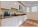 Kitchenette featuring granite countertops, white cabinets, stainless steel microwave, and recessed lighting at 7415 Northampton Ct, Cumming, GA 30040