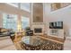 Bright living room with fireplace, large windows, and comfortable seating arrangement at 7415 Northampton Ct, Cumming, GA 30040