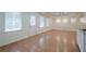 Open-concept living room with wood flooring, recessed lighting, and natural light at 7415 Northampton Ct, Cumming, GA 30040