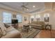 Living room with a comfortable sofa, a patterned rug, and natural light streaming through the windows at 7415 Northampton Ct, Cumming, GA 30040