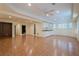 Open-concept living area with an area for dining, hardwood floors, and neutral paint at 7415 Northampton Ct, Cumming, GA 30040