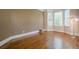 Bright living room featuring hardwood floors, large windows, and neutral paint at 7415 Northampton Ct, Cumming, GA 30040