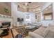 Elegant living room featuring a fireplace, built-in shelving, and plenty of natural light at 7415 Northampton Ct, Cumming, GA 30040