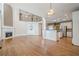 Open concept living area with hardwood floors, fireplace, and views of the kitchen and upper level at 7415 Northampton Ct, Cumming, GA 30040