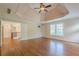 Spacious main bedroom featuring hardwood floors, tray ceilings, and access to hallway at 7415 Northampton Ct, Cumming, GA 30040