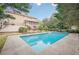Backyard view showcasing the beautiful in-ground pool with mature trees and landscaping at 7415 Northampton Ct, Cumming, GA 30040