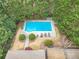Aerial view of a private in-ground pool surrounded by mature trees and meticulously kept landscaping at 7415 Northampton Ct, Cumming, GA 30040