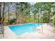 Outdoor pool, surrounded by a concrete patio, perfect for entertaining or relaxation at 7415 Northampton Ct, Cumming, GA 30040