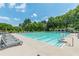 Large community pool with lap lanes, comfortable lounge chairs, and beautiful green surroundings at 7415 Northampton Ct, Cumming, GA 30040