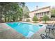 Backyard swimming pool with ample seating and a screened in porch of a two-story house at 7415 Northampton Ct, Cumming, GA 30040