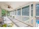 Bright screened-in porch with neutral finishes and outdoor view of backyard and sunlight at 7415 Northampton Ct, Cumming, GA 30040