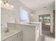 Bright bathroom featuring dual sinks, white cabinets, framed mirrors, soaking tub, and a separate shower at 13244 Tolstoy, Covington, GA 30014