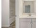 Bathroom vanity with modern fixtures, a mirror, and a shower with modern tile at 13244 Tolstoy, Covington, GA 30014