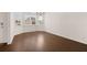 Sun-drenched dining area with hardwood floors, complemented by large windows and modern light fixture at 13244 Tolstoy, Covington, GA 30014