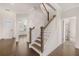 Open entryway featuring hardwood floors, staircase, and view into the living area at 13244 Tolstoy, Covington, GA 30014