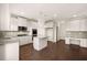 Spacious kitchen with stainless appliances, stone countertops, a center island and hardwood flooring at 13244 Tolstoy, Covington, GA 30014