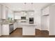 Modern kitchen features stainless steel appliances, a kitchen island, and a pantry at 13244 Tolstoy, Covington, GA 30014