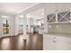 Bright kitchen with white cabinets, stainless appliances, granite countertops, and hardwood floors at 13244 Tolstoy, Covington, GA 30014