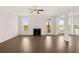 Spacious living room featuring a fireplace, ceiling fan, large windows, and hardwood floors at 13244 Tolstoy, Covington, GA 30014