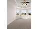 Large, carpeted main bedroom with tray ceiling, fan and a bay window view at 13244 Tolstoy, Covington, GA 30014