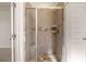 Modern walk-in shower with tiled walls, a built-in bench, and glass door at 13244 Tolstoy, Covington, GA 30014