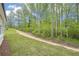 New home backyard featuring green grass and newly planted trees at 3953 Brushy St, Powder Springs, GA 30127