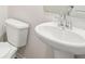 Bathroom featuring a white toilet and pedestal sink at 3953 Brushy St, Powder Springs, GA 30127