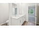 Bright bathroom featuring a double vanity with white cabinets and chrome fixtures at 3953 Brushy St, Powder Springs, GA 30127