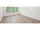 Well-lit bedroom featuring wood floors and three large windows at 3953 Brushy St, Powder Springs, GA 30127