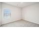 Bright bedroom featuring a window and neutral carpet at 3953 Brushy St, Powder Springs, GA 30127