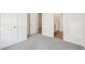 Spacious bedroom with carpet, open doorways and neutral walls at 3953 Brushy St, Powder Springs, GA 30127