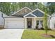 Charming single-story home with brick and stone accents, complemented by a well-manicured lawn and a two-car garage at 3953 Brushy St, Powder Springs, GA 30127