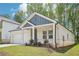 Well-maintained home with brick accents, a two-car garage, and manicured lawn featuring lush green grass and mature trees at 3953 Brushy St, Powder Springs, GA 30127