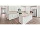 Modern kitchen with white cabinets, granite countertops, stainless steel appliances, and a central island with a sink at 3953 Brushy St, Powder Springs, GA 30127