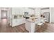 Stylish kitchen featuring white cabinets, stainless steel appliances, granite countertops, and a functional island with seating at 3953 Brushy St, Powder Springs, GA 30127